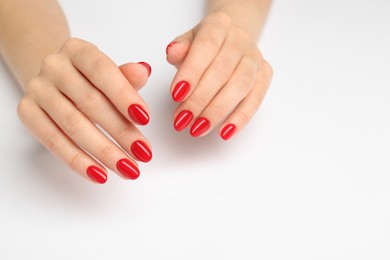 Woman with red polish on nails on white background, closeup. Space for text
