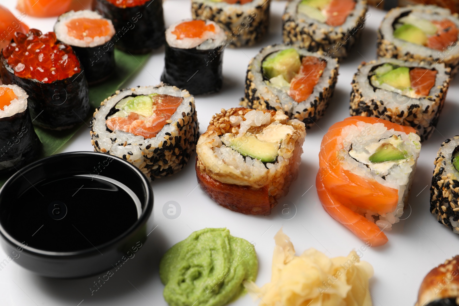 Photo of Set of delicious sushi rolls on white background, closeup