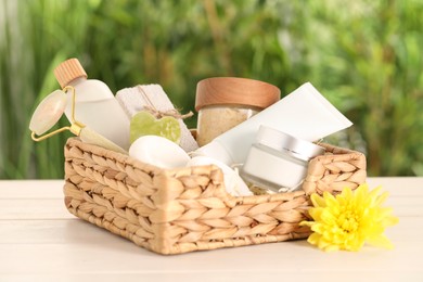 Photo of Spa gift set with different products on white wooden table against blurred background