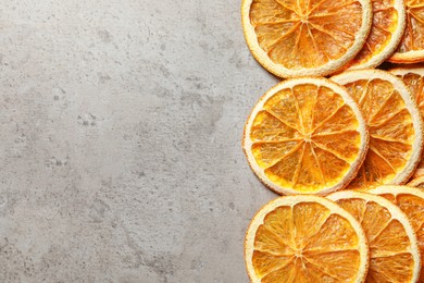 Dry orange slices on light grey table, flat lay. Space for text