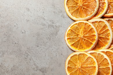 Photo of Dry orange slices on light grey table, flat lay. Space for text