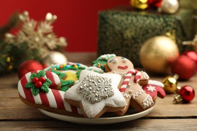 Photo of Sweet Christmas cookies and festive decor on wooden table