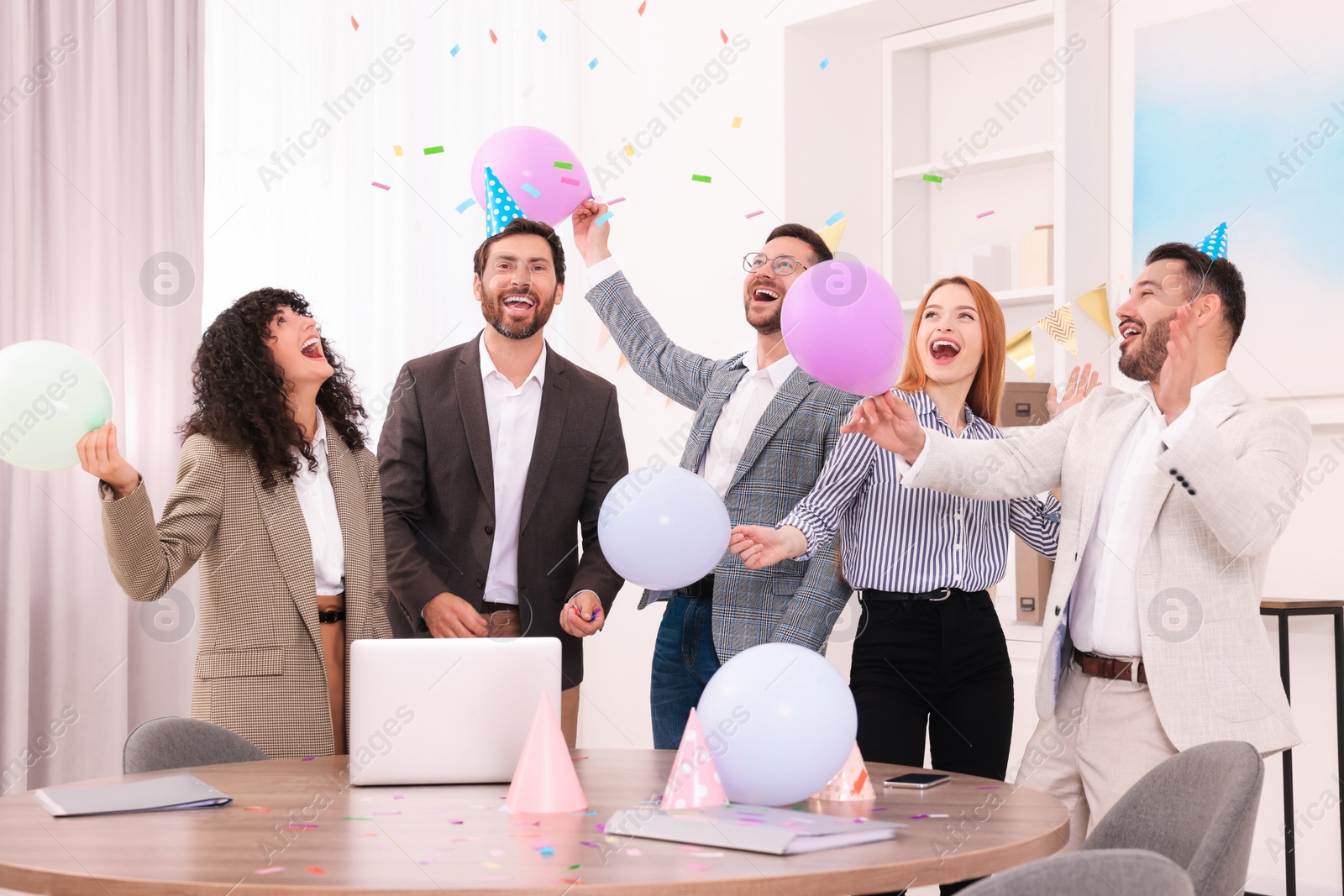 Photo of Coworkers having fun during office party indoors