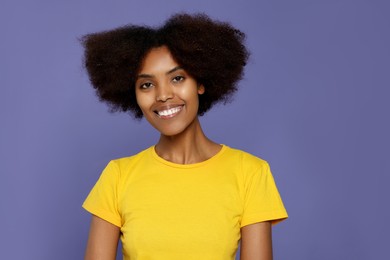Photo of Portrait of smiling African American woman on purple background