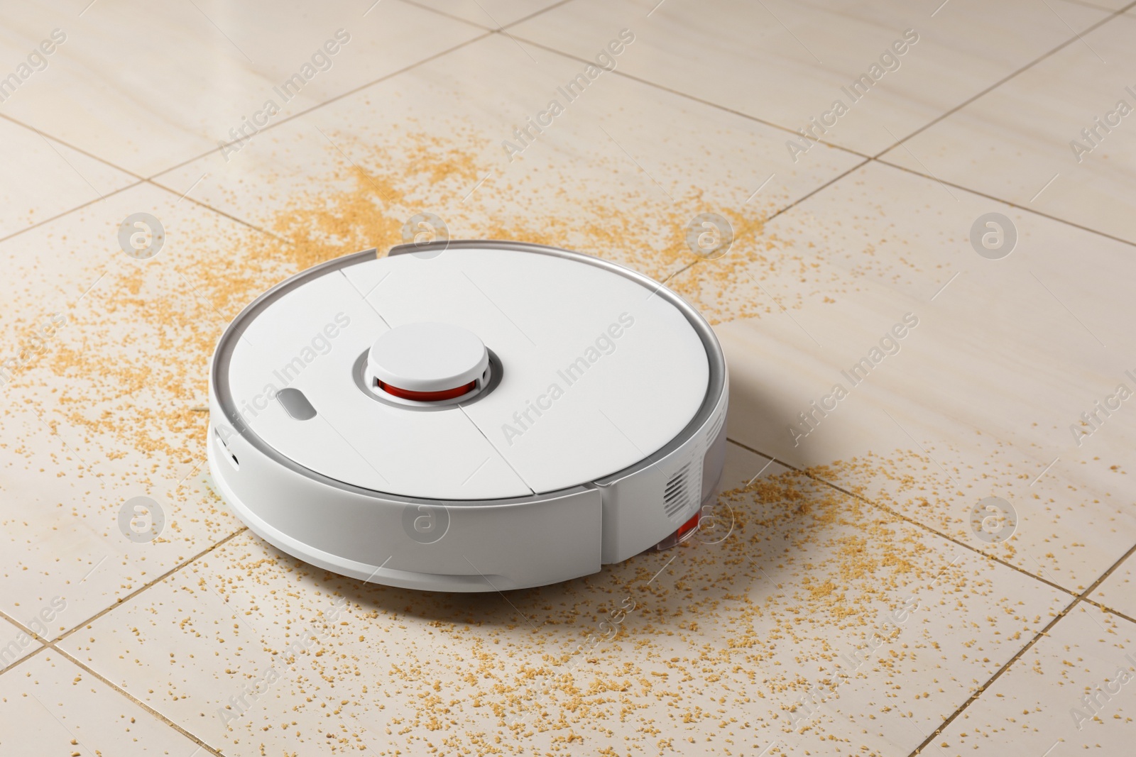 Photo of Robot vacuum cleaner removing dirt from floor in room