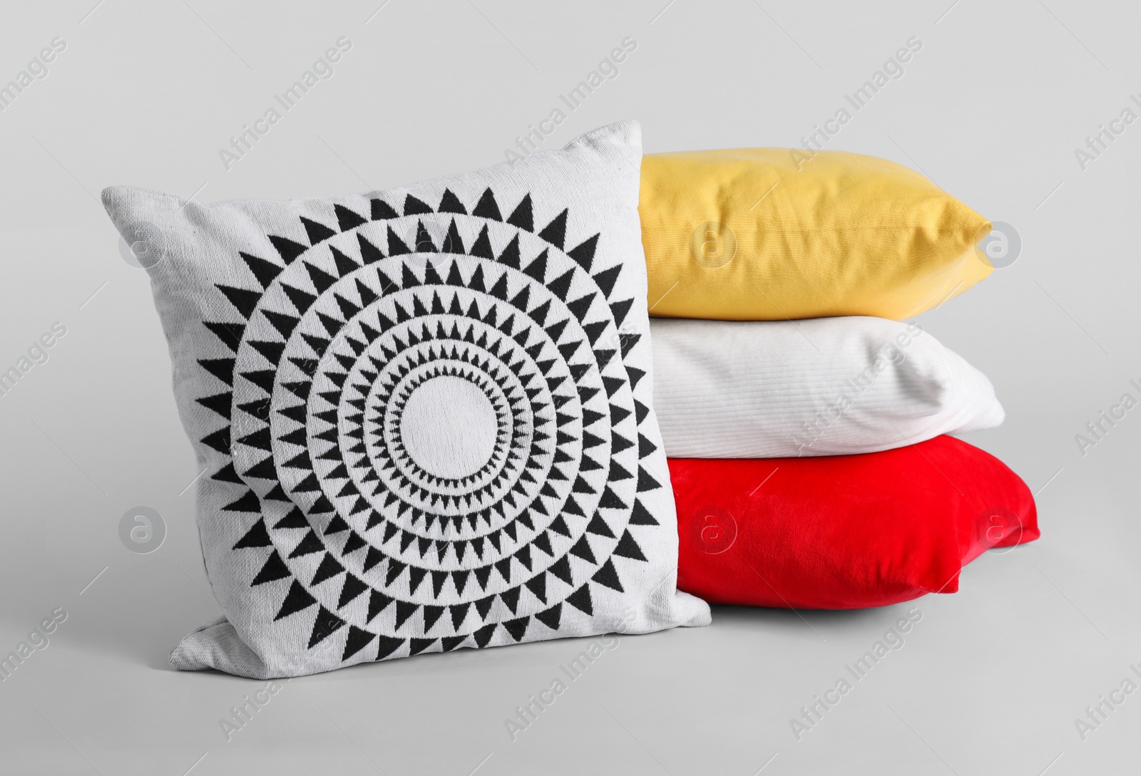 Photo of Different stylish soft pillows on grey background