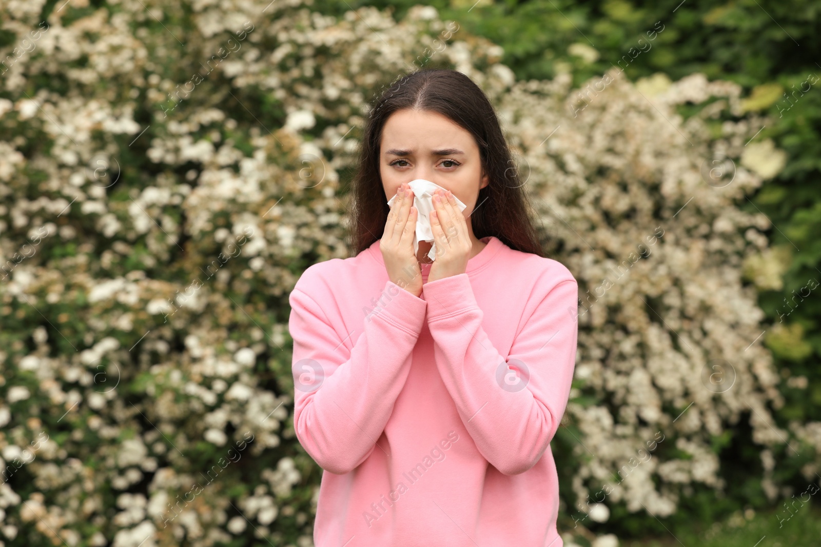 Photo of Woman suffering from seasonal spring allergy outdoors