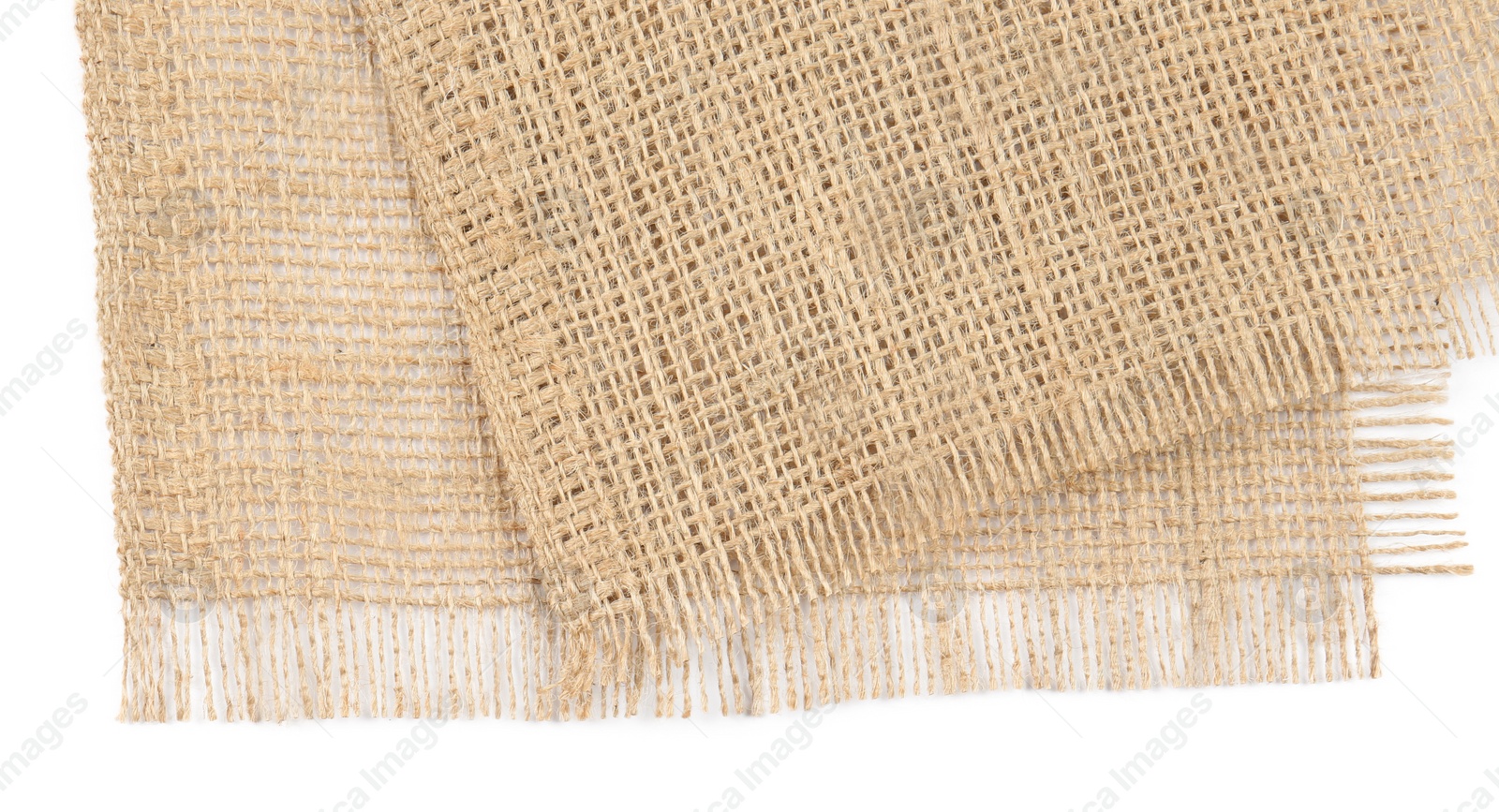 Photo of Pieces of burlap fabric isolated on white, top view
