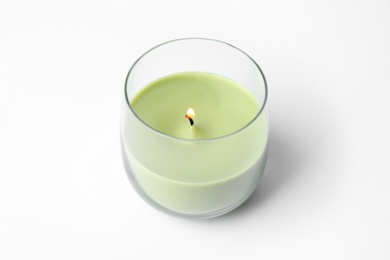 Green wax candle in glass holder isolated on white