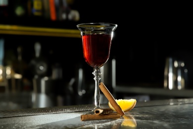 Photo of Fresh red cinnamon whiskey alcoholic cocktail on bar counter