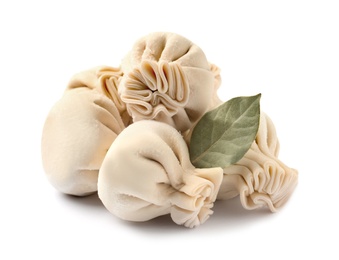 Photo of Pile of raw dumplings with bay leaf on white background