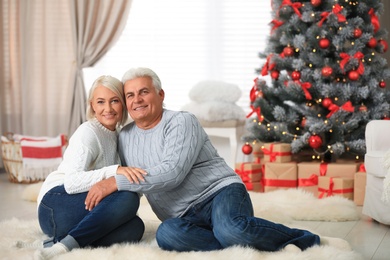 Happy mature couple at home. Christmas celebration