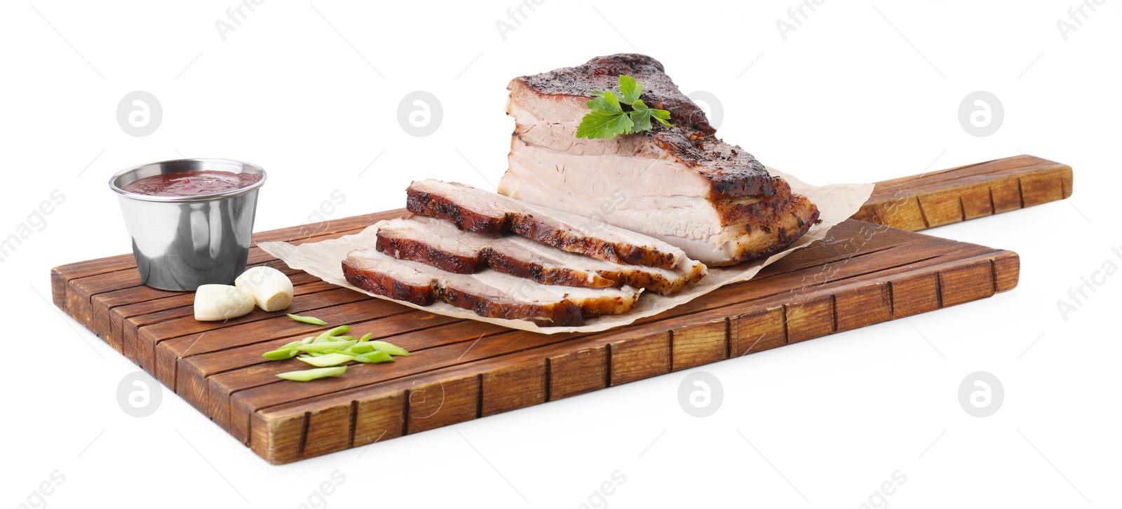 Photo of Pieces of tasty baked pork belly and sauce isolated on white