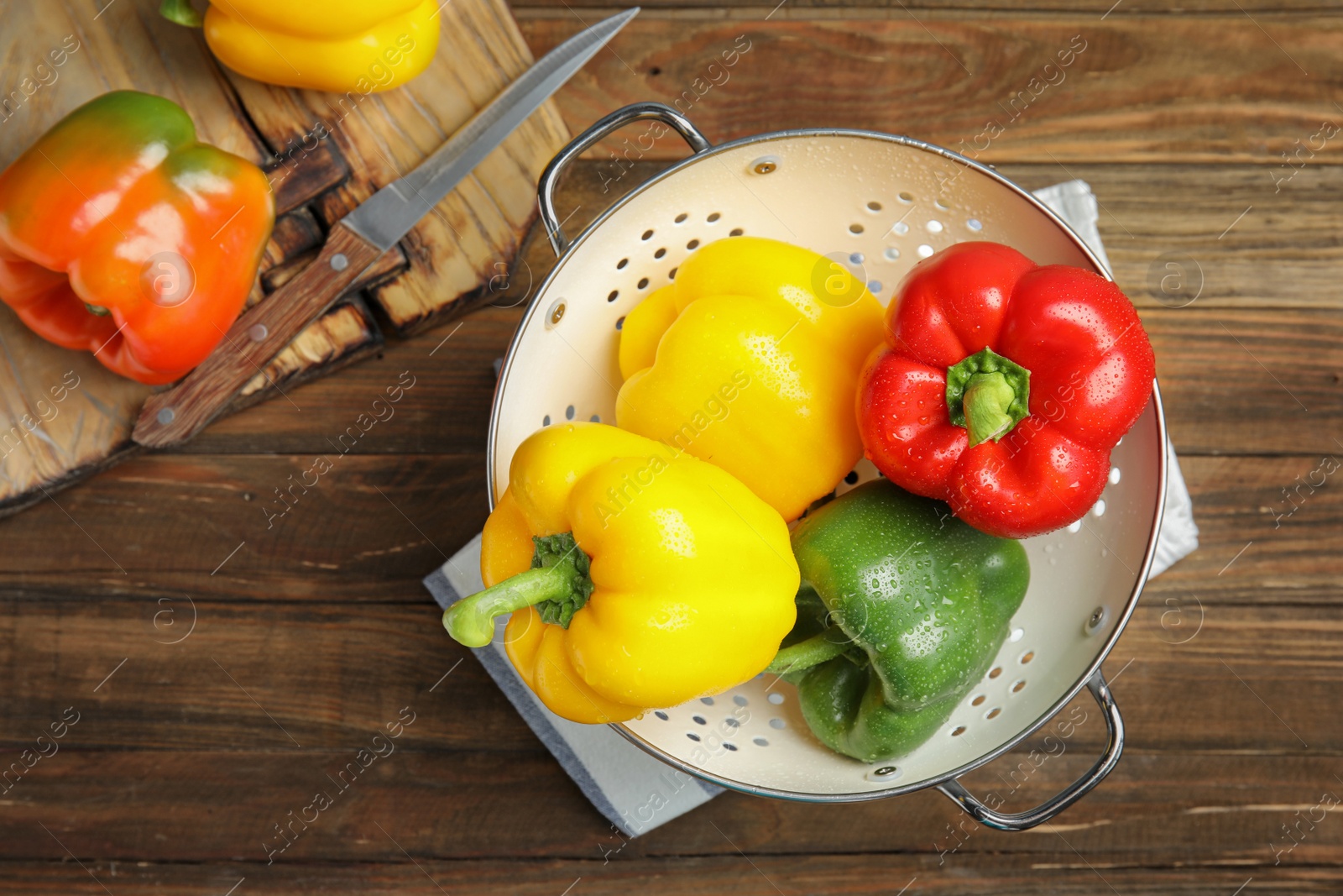 Photo of Raw ripe paprika peppers on wooden table, top view