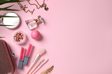 Photo of Flat lay composition with makeup products on pink background, space for text