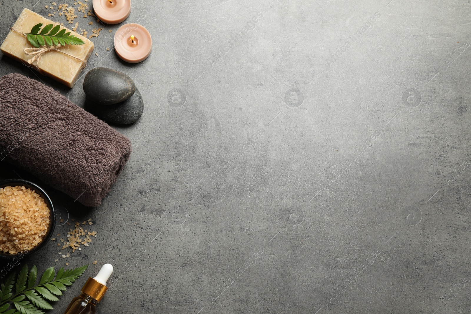 Photo of Flat lay composition with spa stones on grey table, space for text