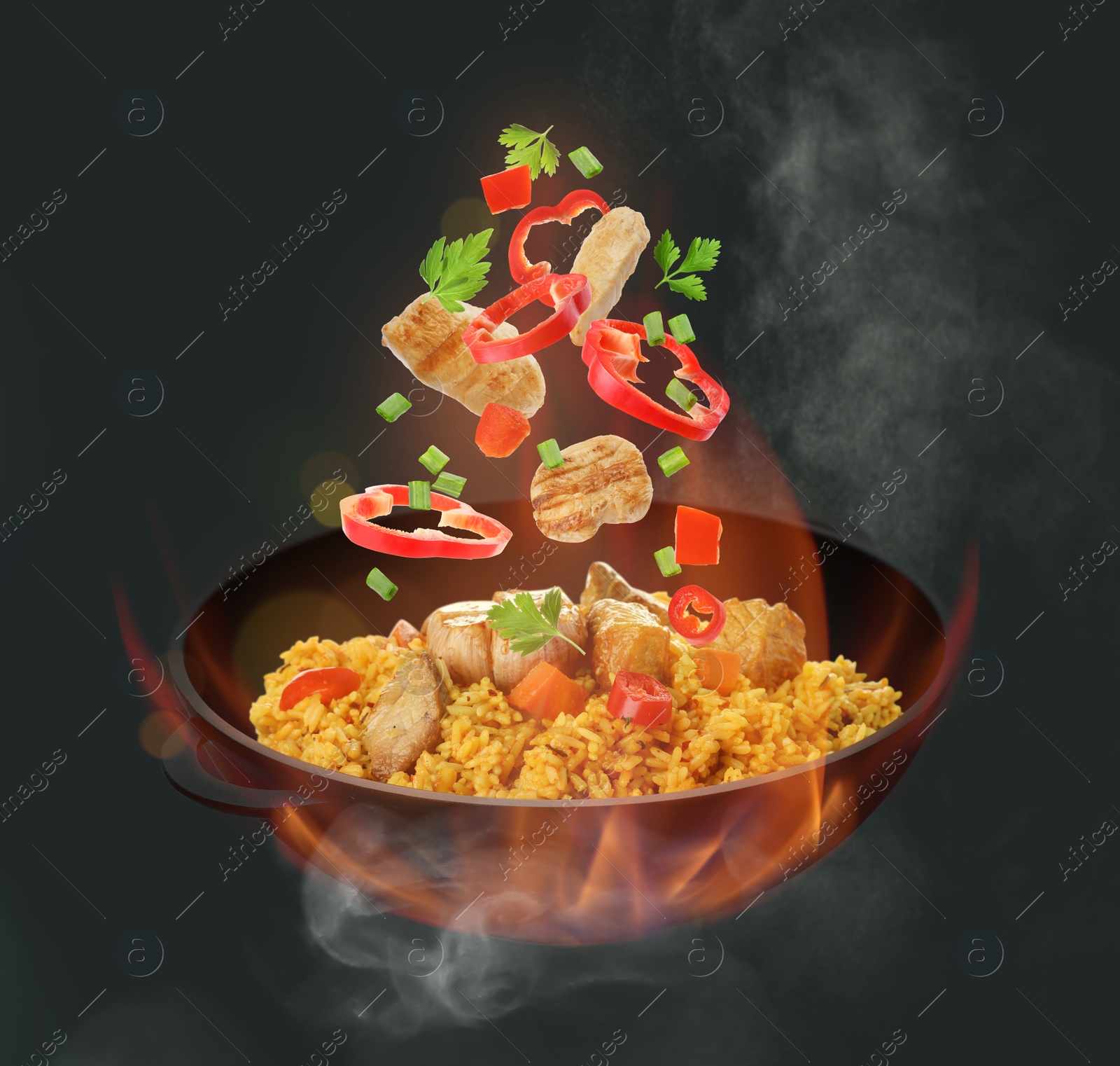 Image of Wok with tasty ingredients and fire on dark background