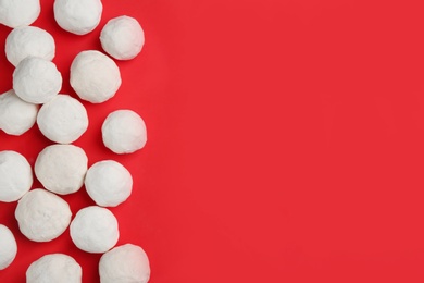 Photo of Snowballs on red background, flat lay. Space for text