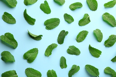 Photo of Fresh mint leaves on light blue background, flat lay