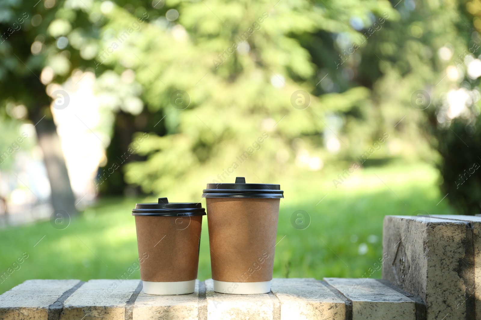 Photo of Paper cups on street outdoors. Takeaway drink