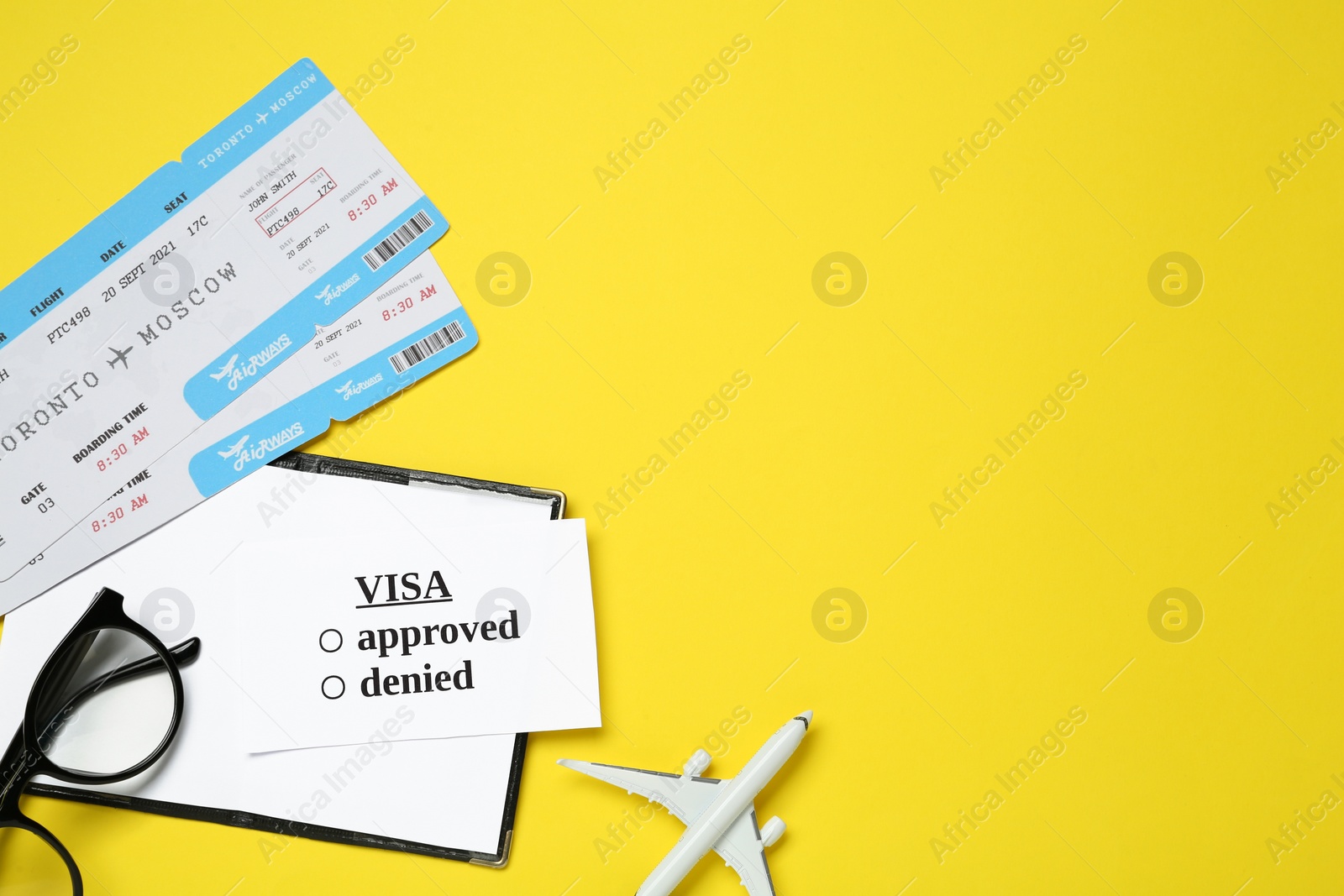 Photo of Flat lay composition with passport, toy plane and tickets on yellow background. Visa receiving