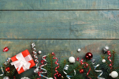 Flat lay composition with serpentine streamers and Christmas decor on blue wooden background. Space for text