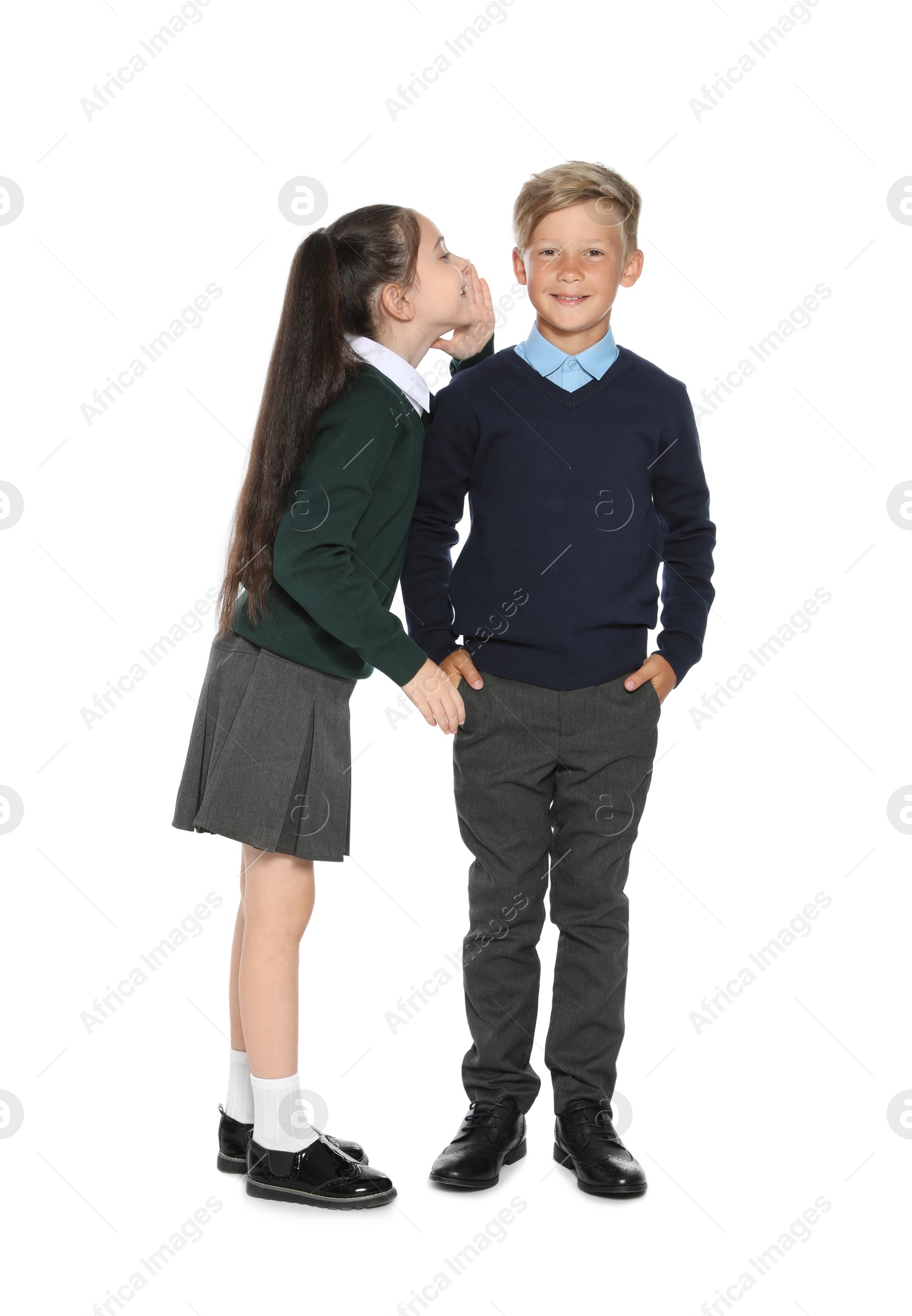 Photo of Little children in stylish school uniform on white background