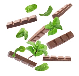 Image of Milk chocolate pieces and mint falling on white background