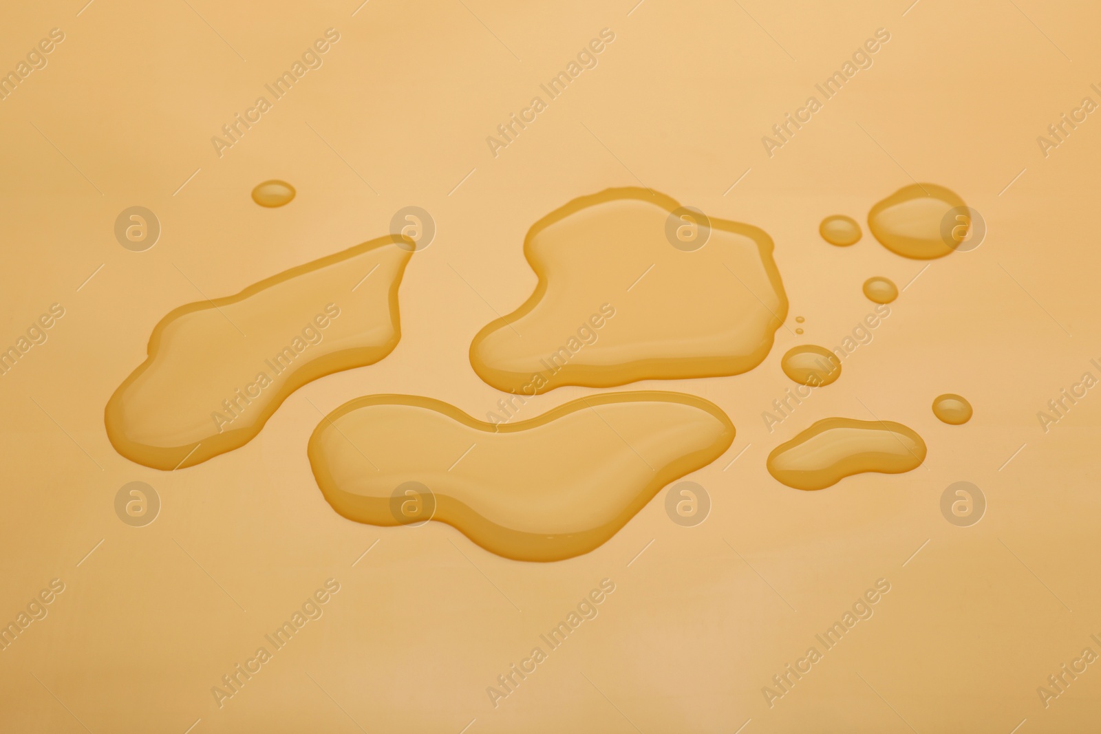 Photo of Puddle of water on pale orange background