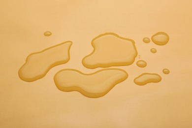 Photo of Puddle of water on pale orange background