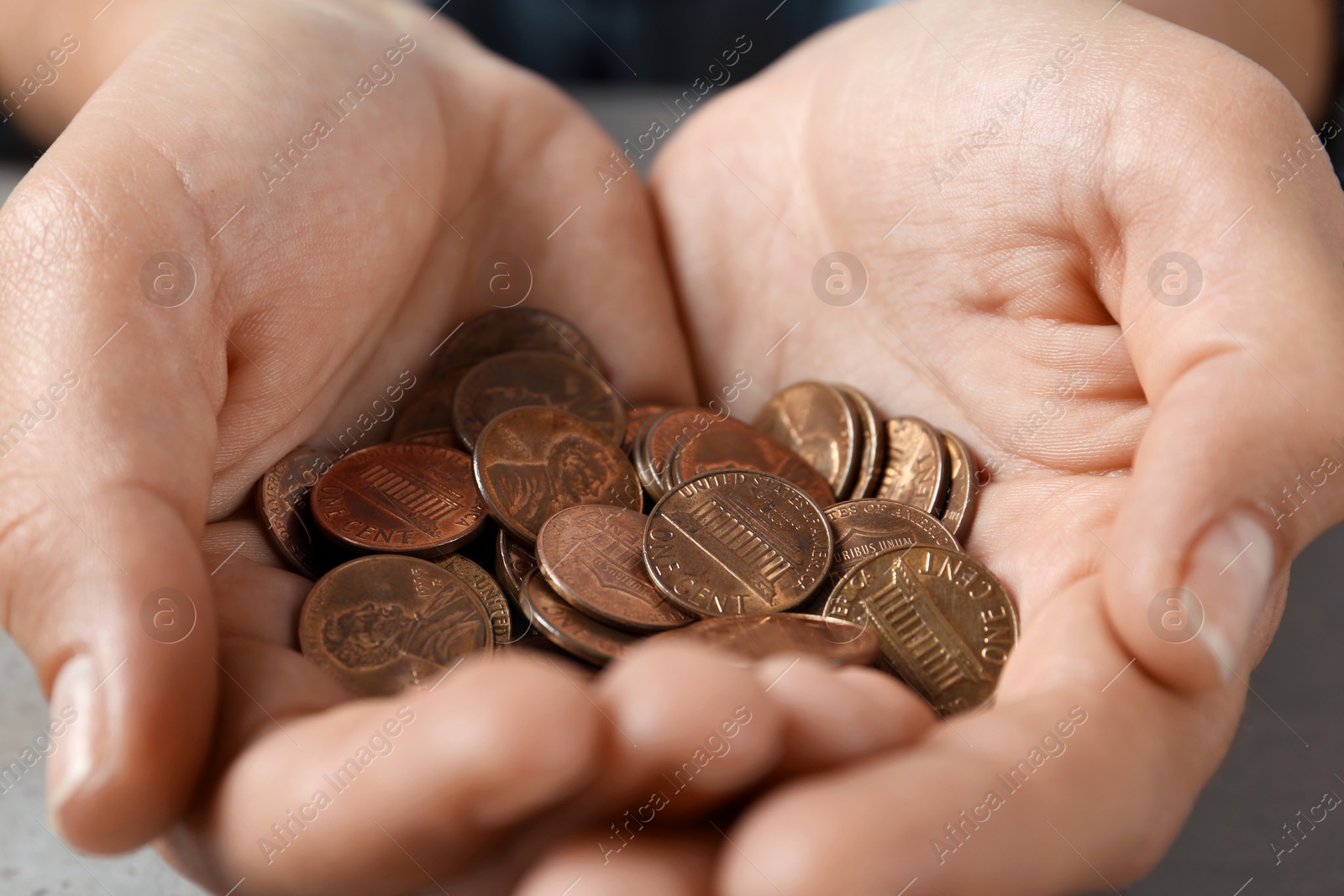 Photo of Young woman holding pile of coins, closeup view