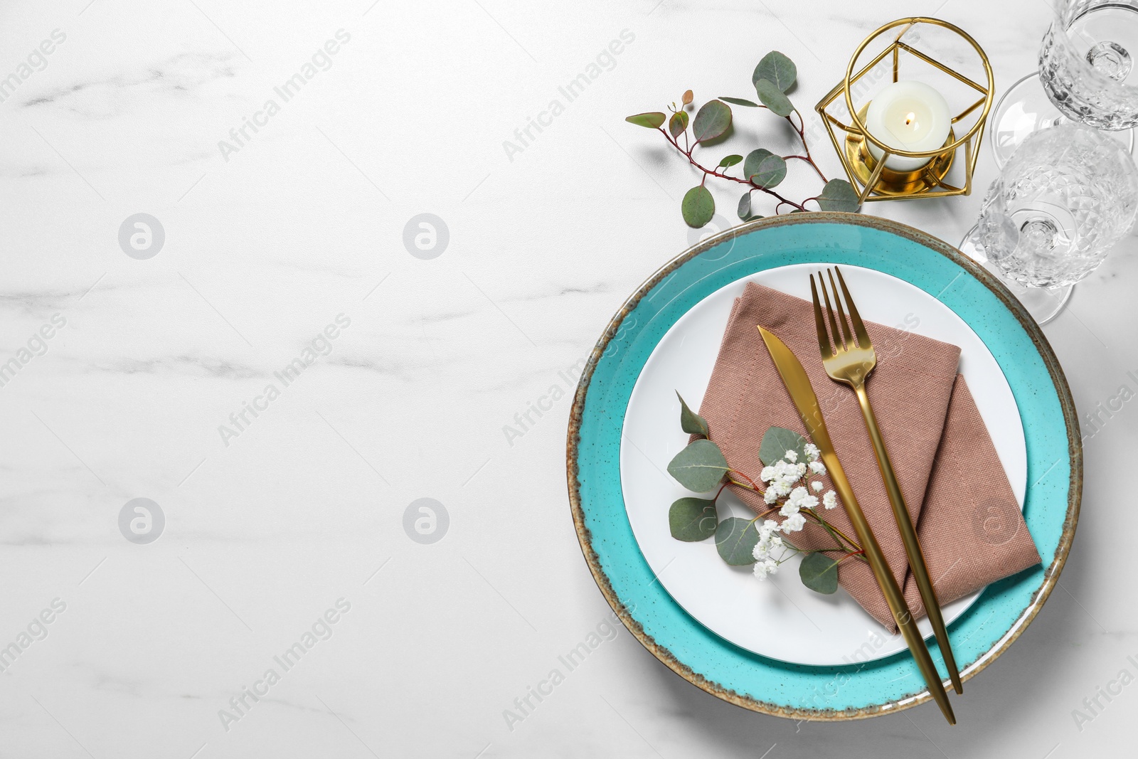 Photo of Stylish table setting with cutlery, flower and eucalyptus leaves, flat lay. Space for text