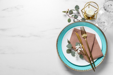 Photo of Stylish table setting with cutlery, flower and eucalyptus leaves, flat lay. Space for text