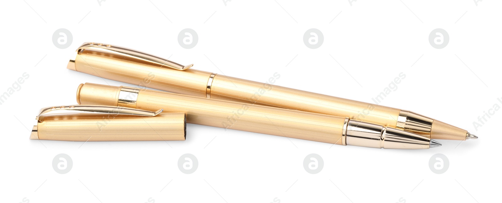 Photo of New stylish golden pens isolated on white
