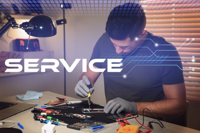 Image of Technician repairing broken smartphone at table indoors