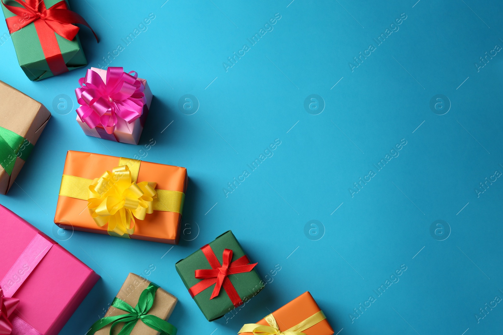 Photo of Many colorful gift boxes on light blue background, flat lay. Space for text