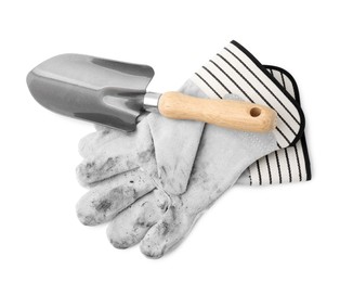 Photo of Pair of color gardening gloves and trowel isolated on white, top view