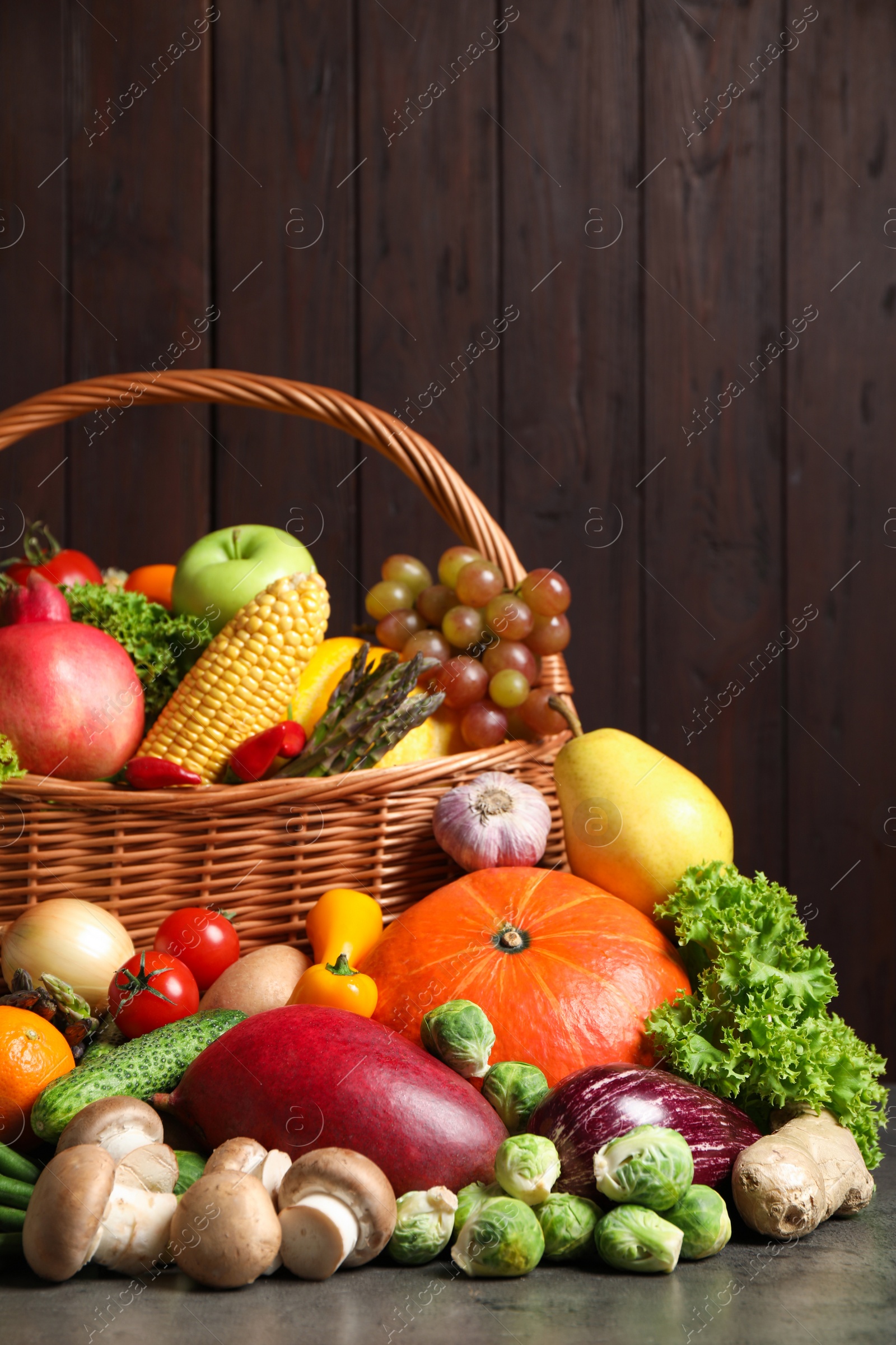 Photo of Assortment of fresh organic fruits and vegetables on grey table