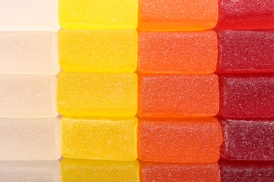 Photo of Tasty colorful jelly candies as background, top view