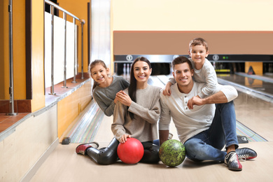 Happy family spending time together in bowling club