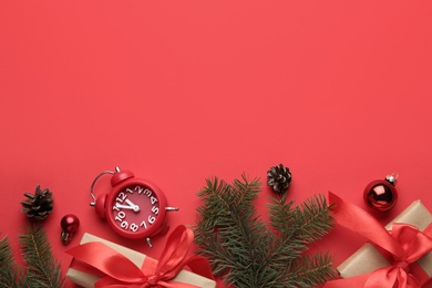 Flat lay composition with alarm clock and gifts on red background, space for text. Boxing day