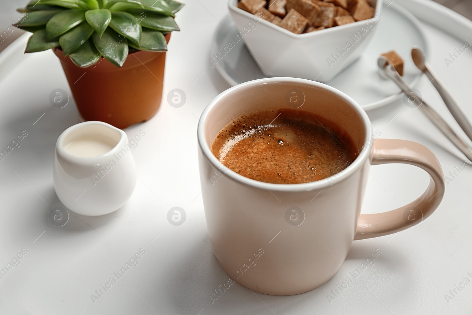 Photo of Cup of delicious hot coffee on table