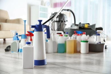 Professional cleaning supplies and equipment on floor indoors. Space for text