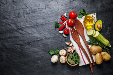 Flat lay composition with fresh products on grey table, space for text. Healthy cooking