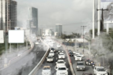 Image of Environmental pollution. Air contaminated with fumes in city. Cars surrounded by exhaust on road, blurred view