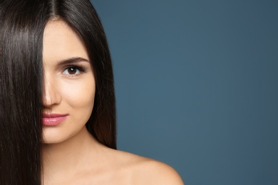 Portrait of beautiful model with gorgeous straight hair on color background