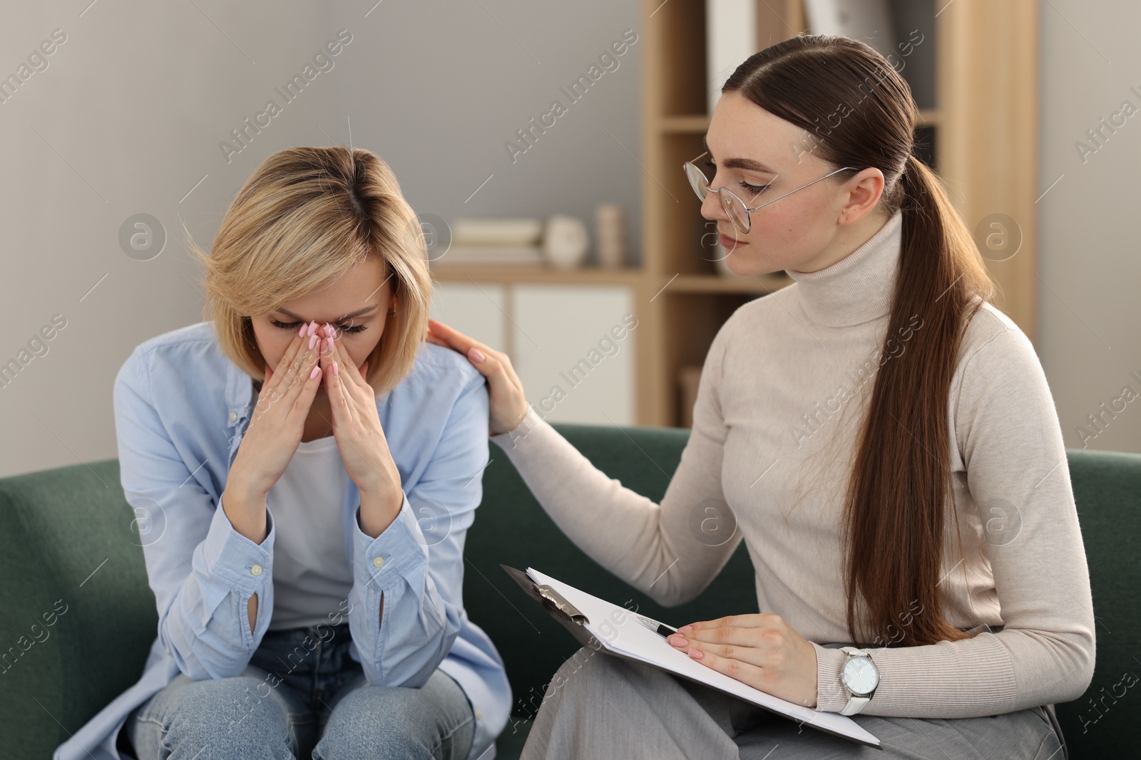 Photo of Psychotherapist working with patient on sofa in office