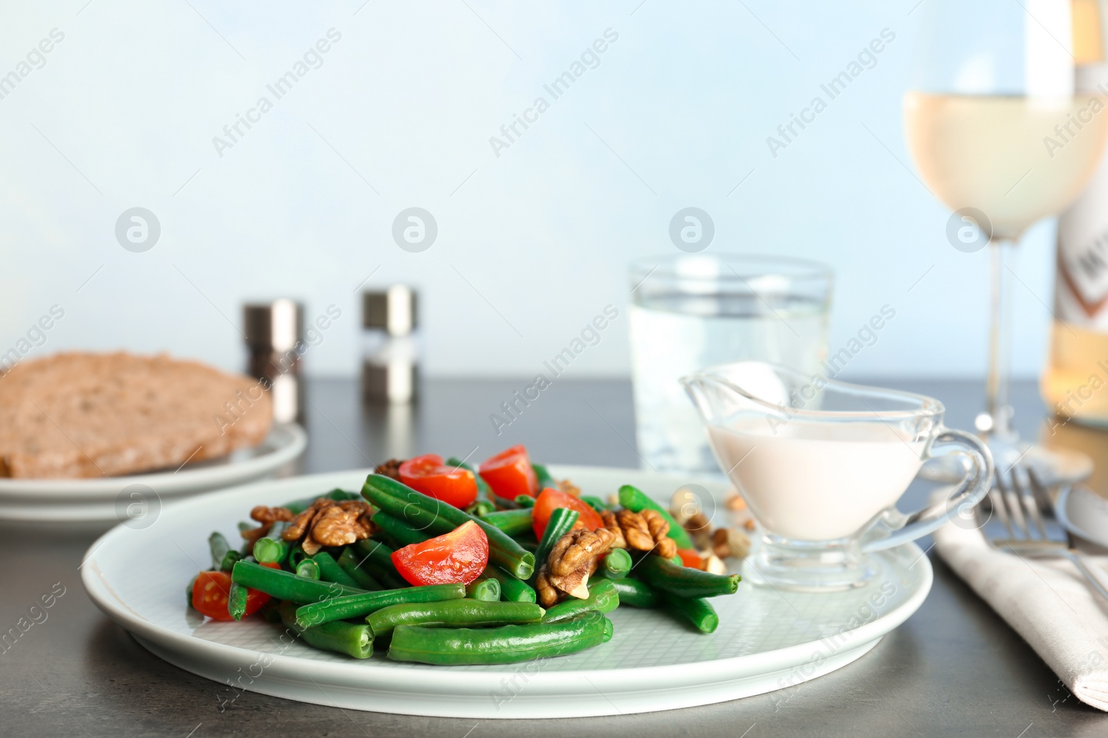 Photo of Plate of fresh green bean salad on table