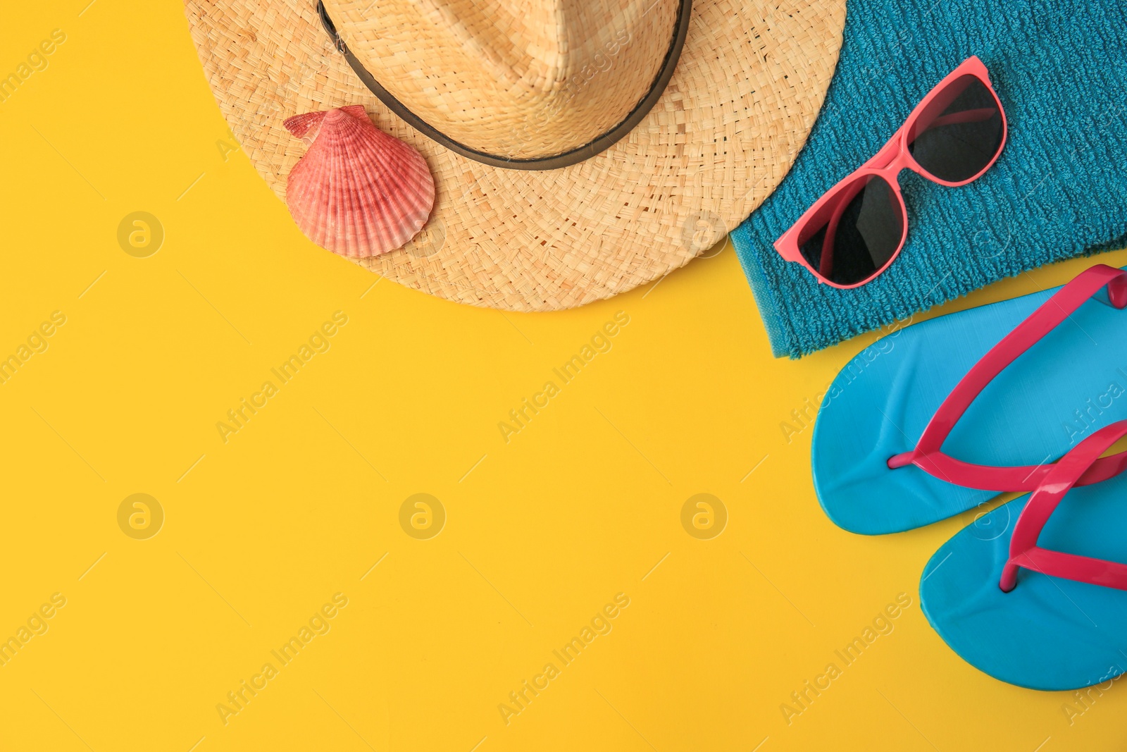 Photo of Flat lay composition with different beach accessories on yellow background. Space for text