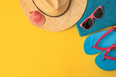 Photo of Flat lay composition with different beach accessories on yellow background. Space for text